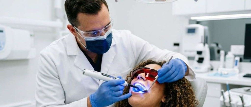 Dentist using advanced laser technology during a preventive family dentistry visit at Mississauga Smiles Dentistry in Mississauga.