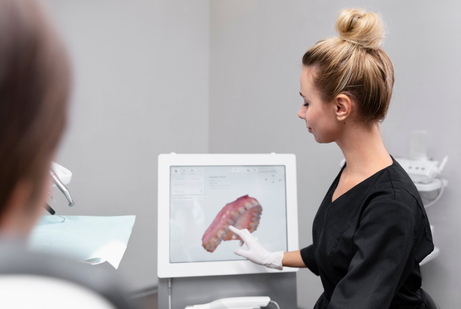 Dentist consulting a patient for SomnoMed oral appliance using panoramic X-ray of the jaw.