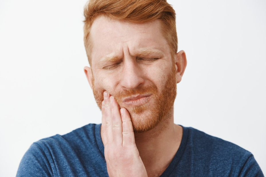 Man expressing severe facial pain, highlighting urgent TMD symptoms or Jaw Dysfunction. Mississauga Smiles Dentistry, Mississauga.