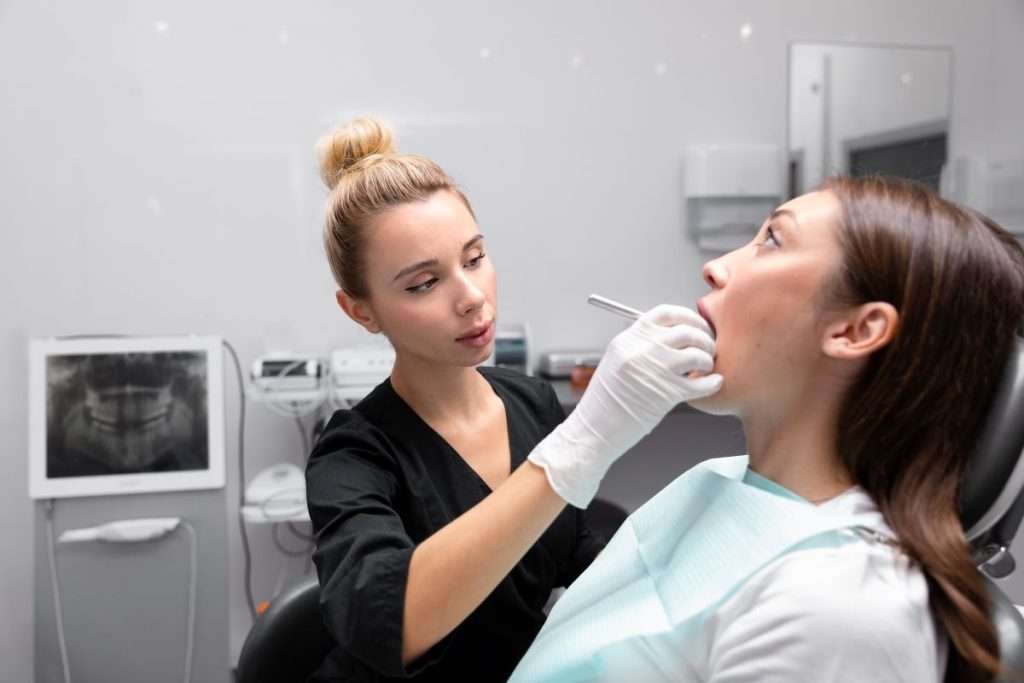 Dental TMD appointment with patient and dentist.
